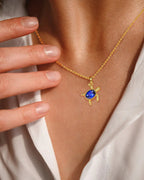 Gold Turtle Necklace with Blue Gem