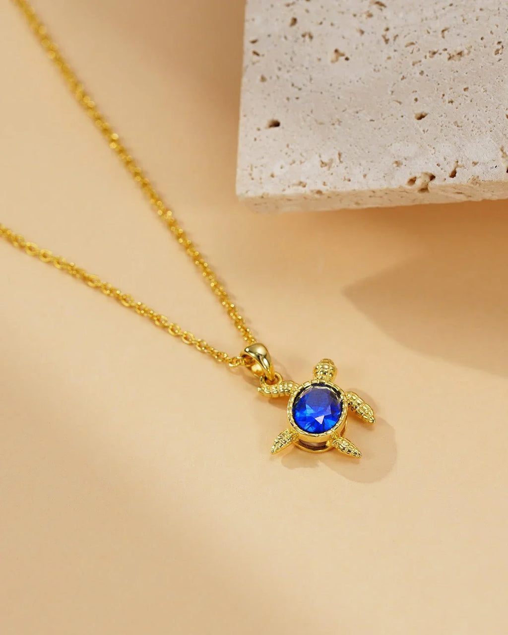 Gold Turtle Necklace with Blue Gem