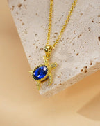 Gold Turtle Necklace with Blue Gem