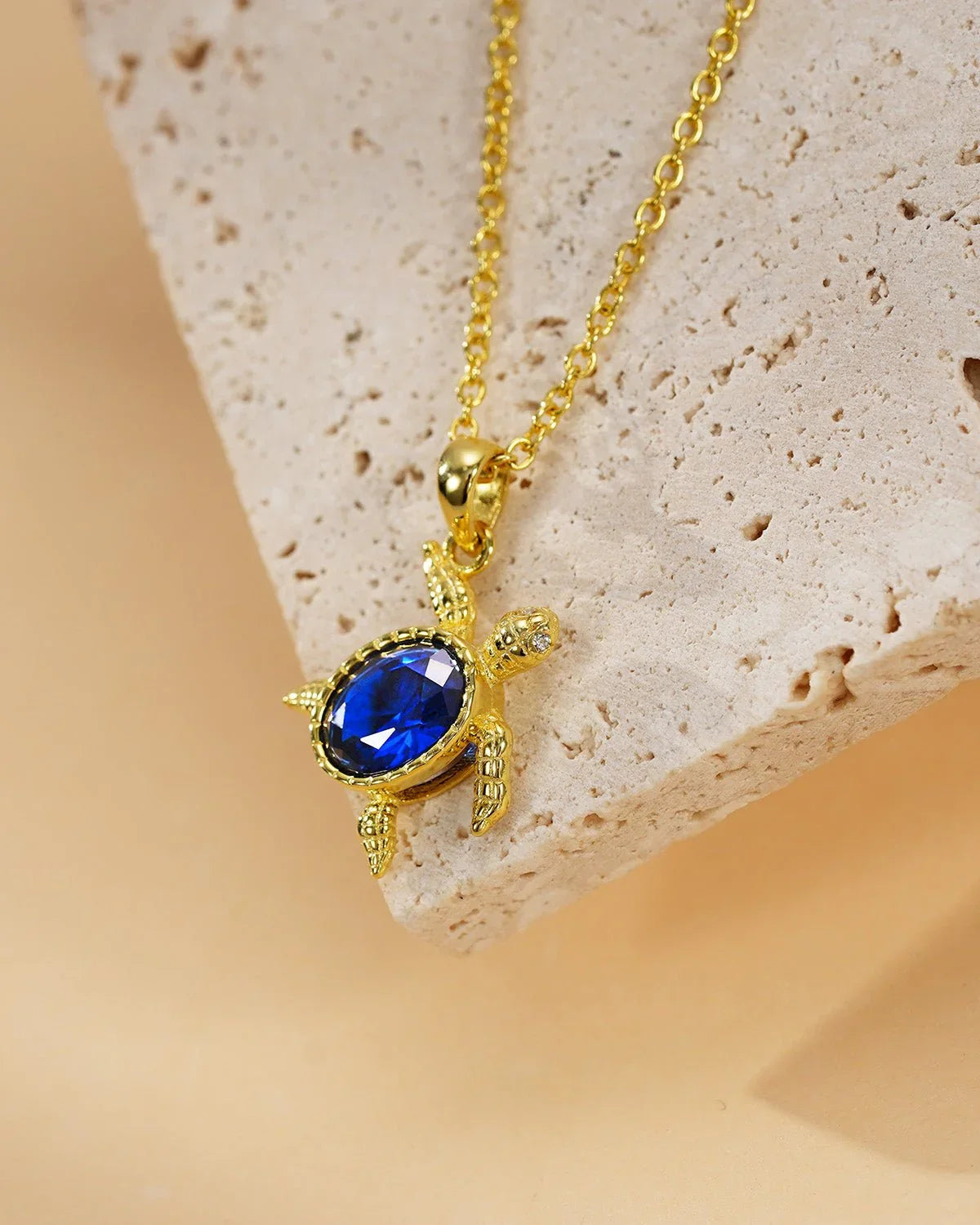 Gold Turtle Necklace with Blue Gem